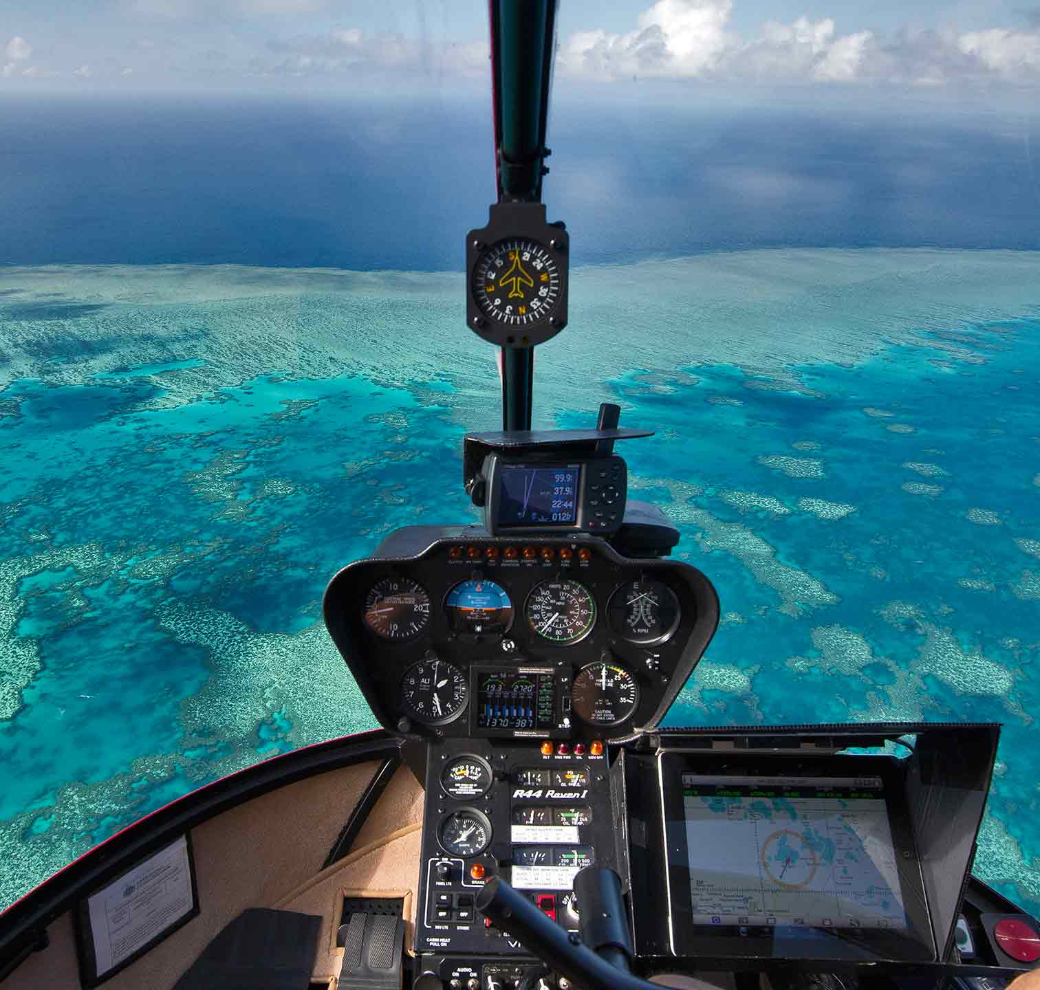 the cockpit of a plane flying over the ocean.
